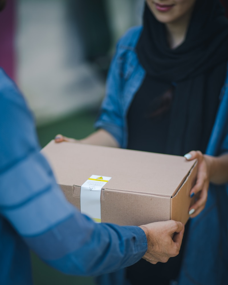 A person handing over a delivery package