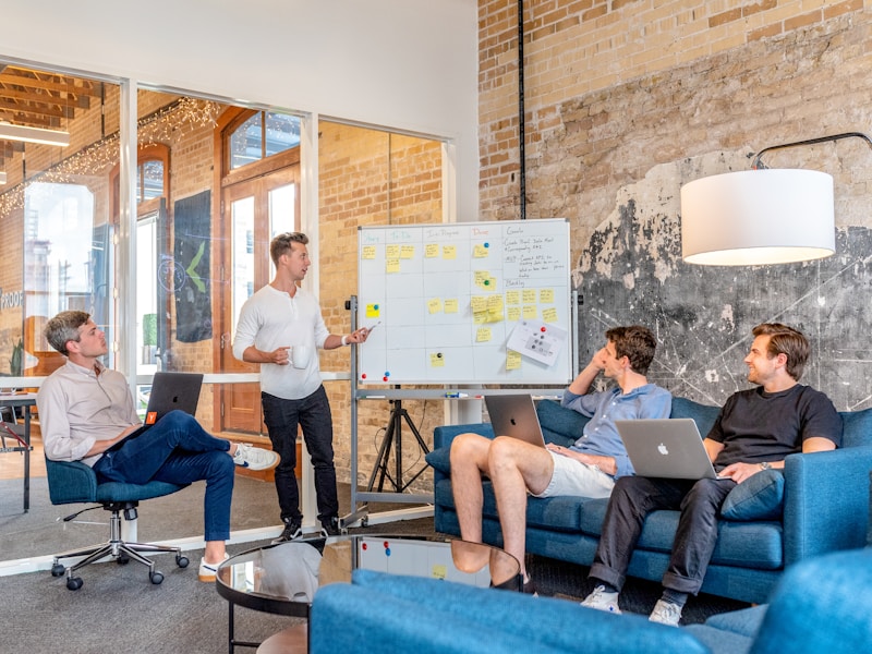 A startup team brainstorming at a whiteboard